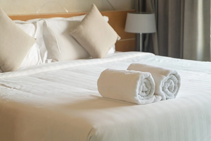 Clean white comforter professionally arranged on a bed in a Jersey Shore short-term vacation rental