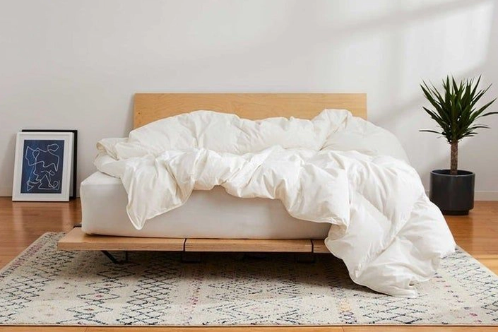 Clean white comforter professionally arranged on a bed in a Jersey Shore short-term vacation rental