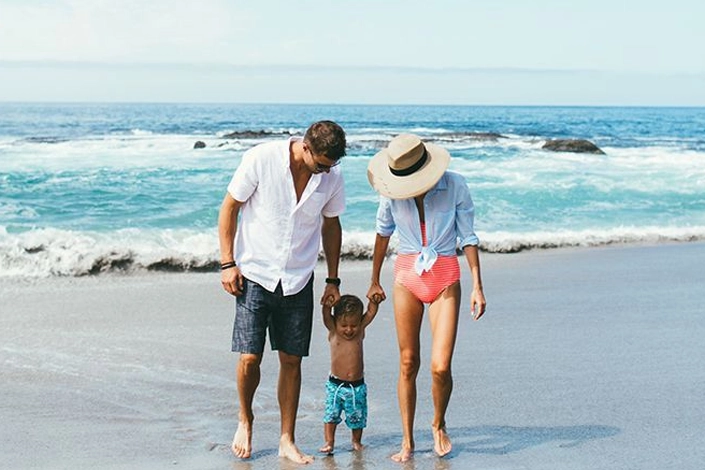 Couple and young child enjoying a premium family beach vacation along the New Jersey shoreline