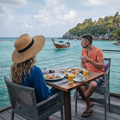 Couple seated at an outdoor waterfront table enjoying breakfast on a carefree Jersey Shore vacation morning